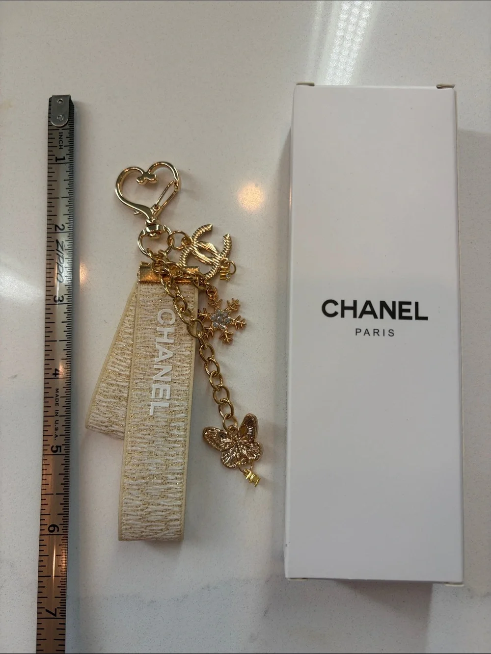 Beige and Gold Logo Strap Keychain with Charms